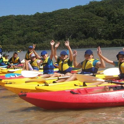group of school children in kayaks